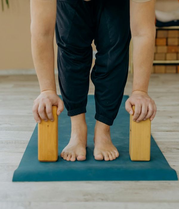 Person holding a challenging yoga pose, demonstrating physical strength and balance.